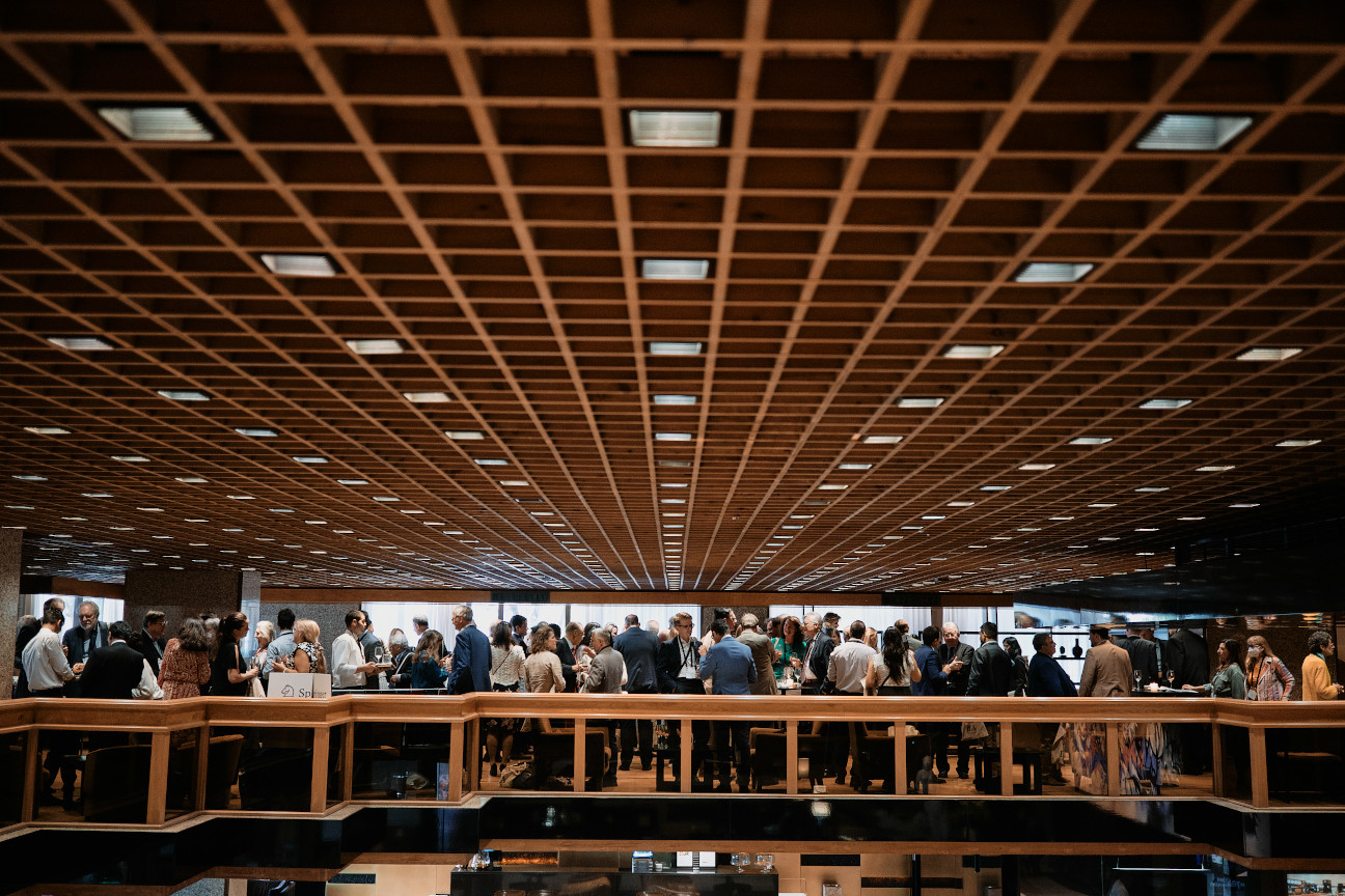view looking across balcony with people participating in a drinks reception