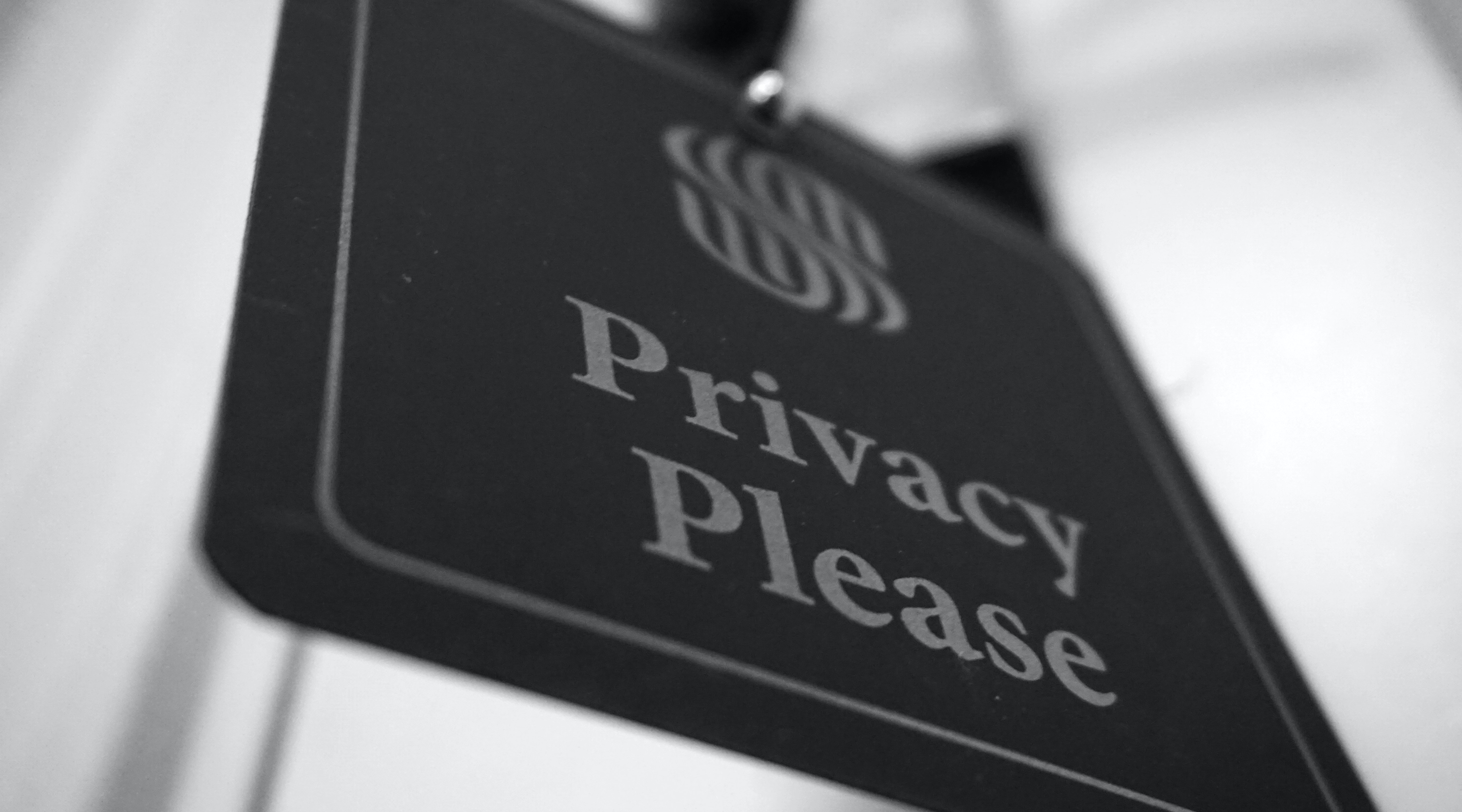 Black and white image of square sign stating Privacy Please